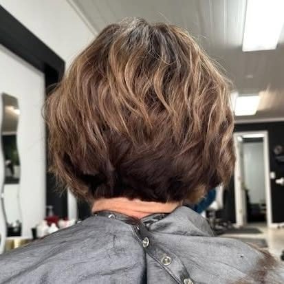 Short blonde highlighted cut.